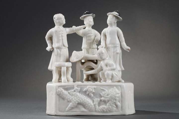 Group porcelain "blanc de Chine " of figures around a game table